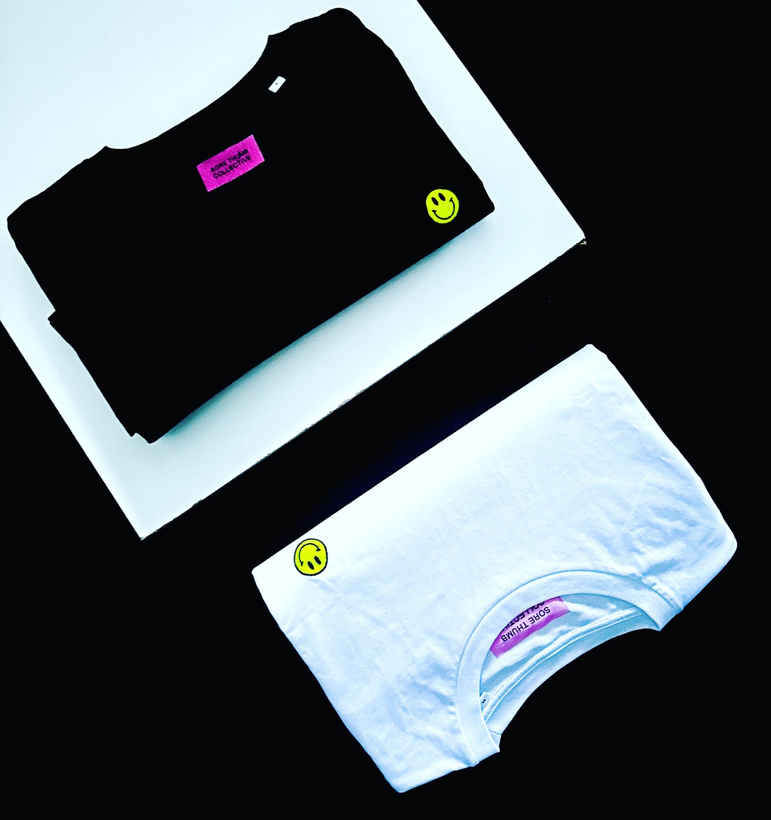 Black and white smiley face t-shirts inspired by acid house and rave culture
