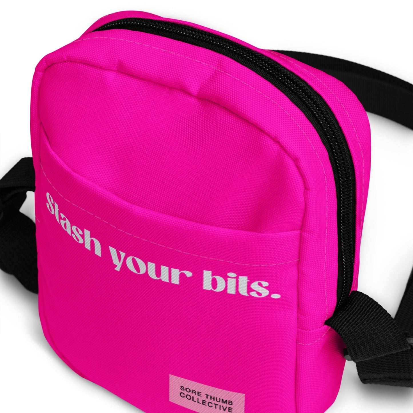 Neon pink cross body bag, with strong strap and zip closure, stash your bits printed text,