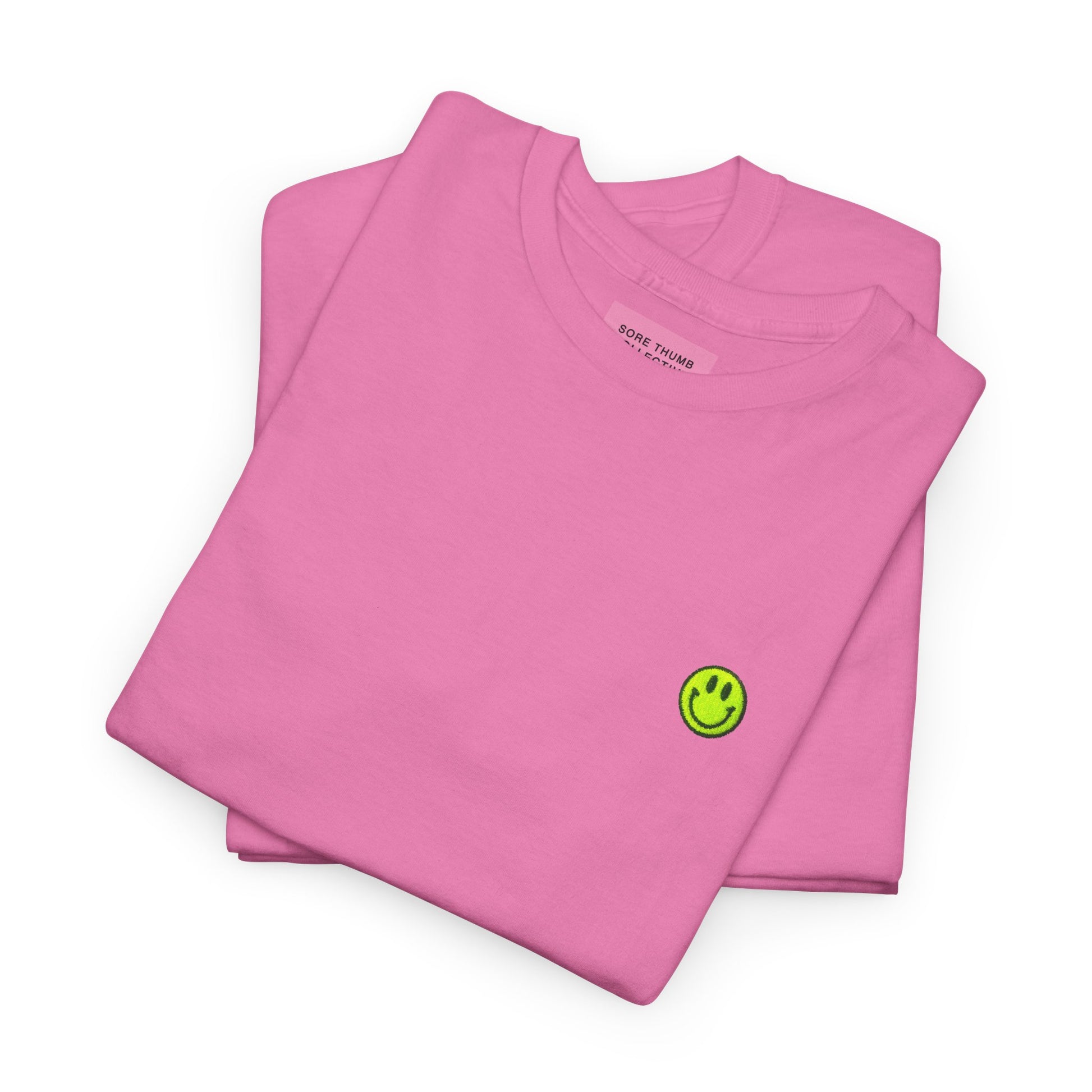 Folded Dusky Pink Smiley Face T Shirt Highlighting Neon Yellow Embroidery