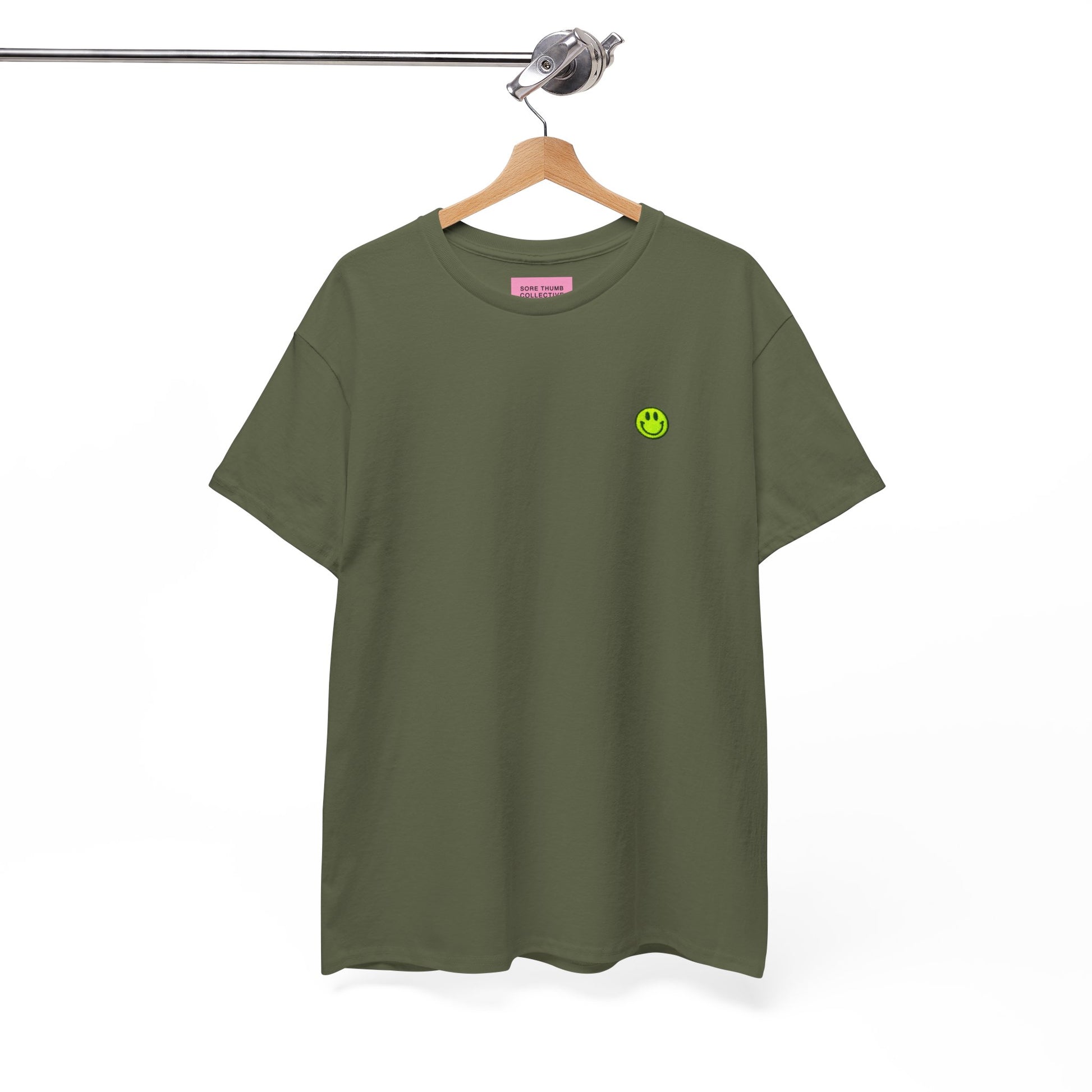 Green t-shirt with a small logo on a hanger against a white background