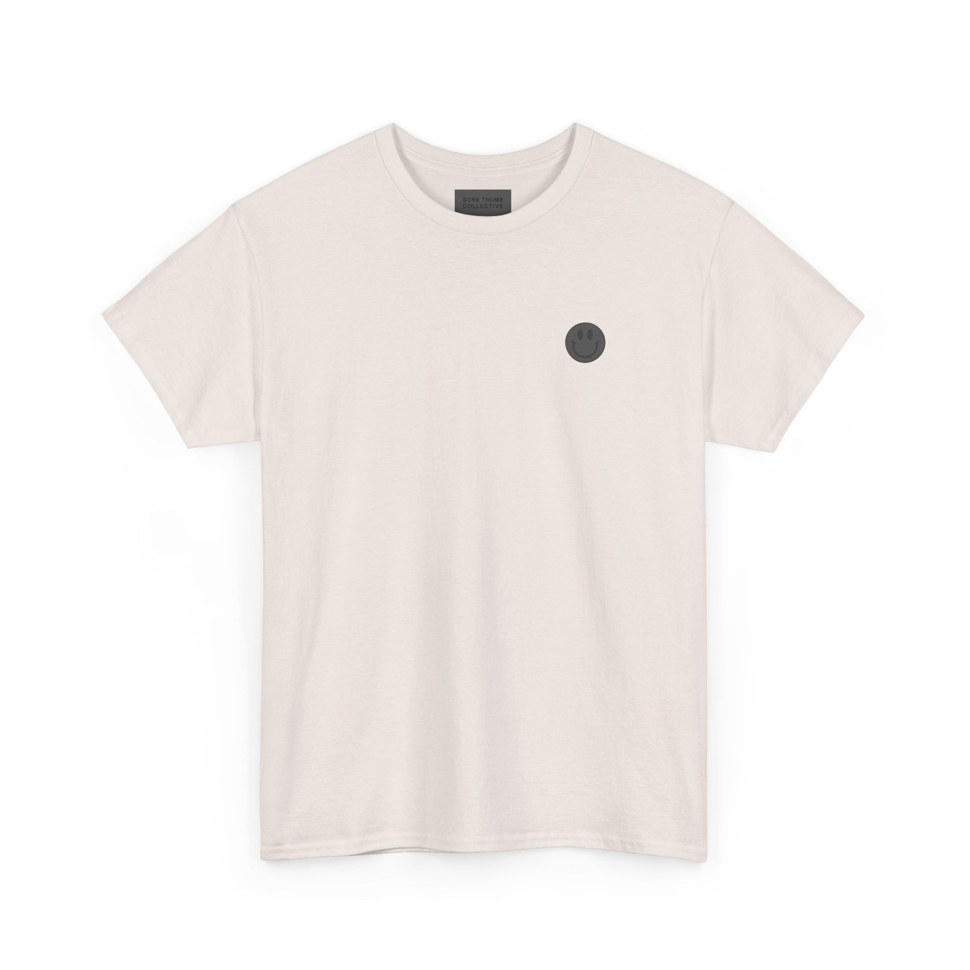 Beige t-shirt with a small black circle design on a white background