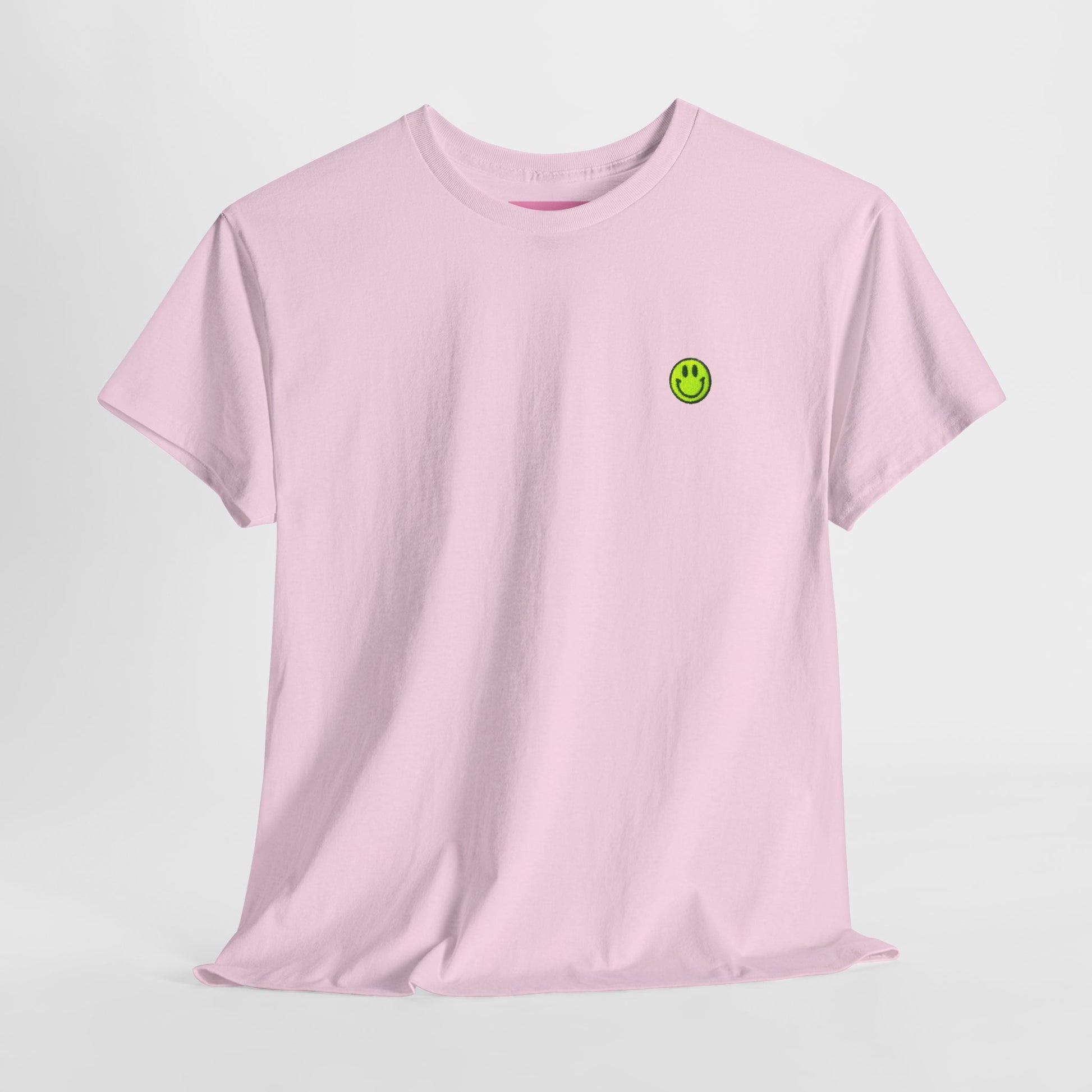 Pink t-shirt with a green smiley face logo on a light gray background