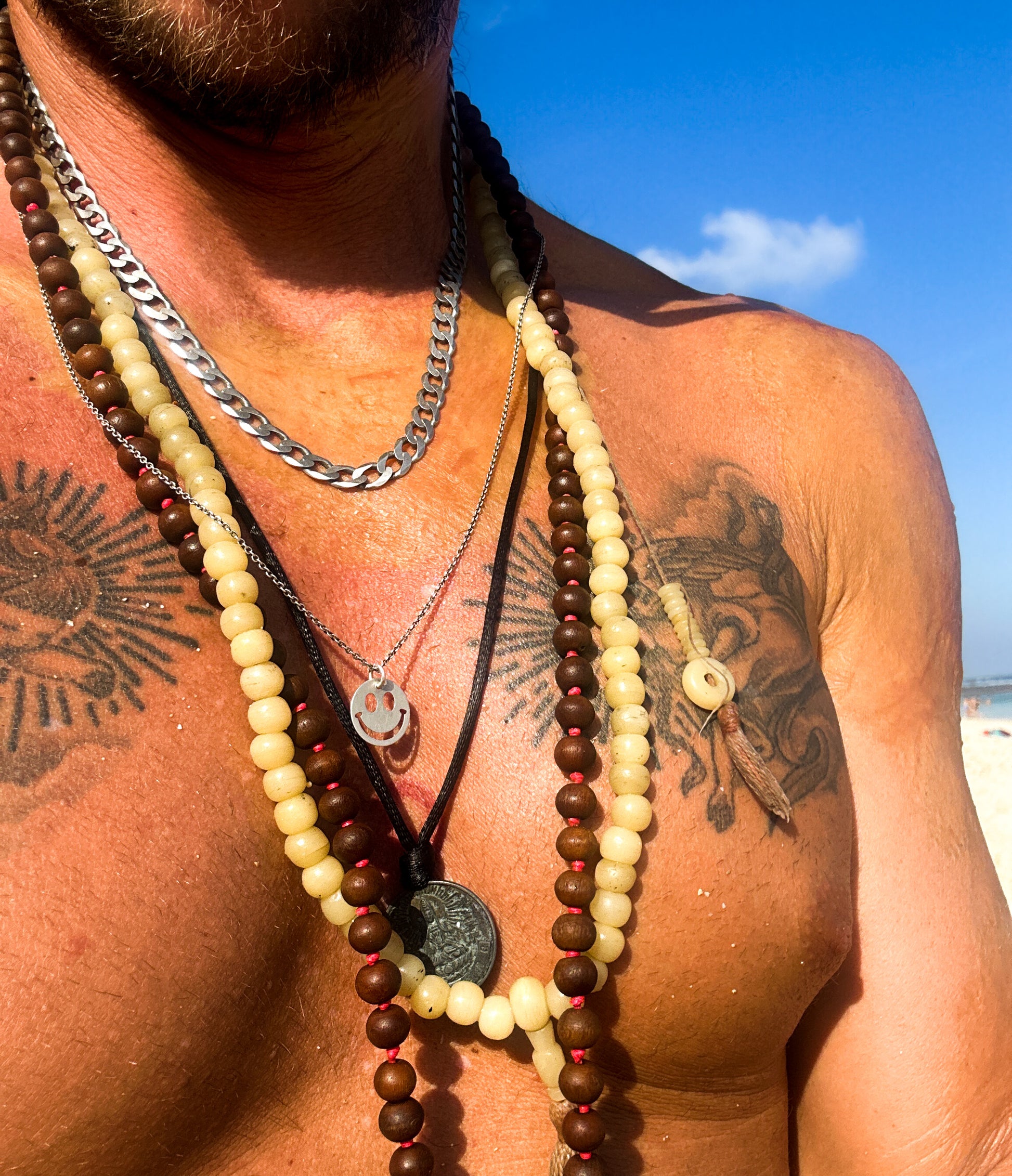 Model wearing smiley face necklace with beach festival outfit