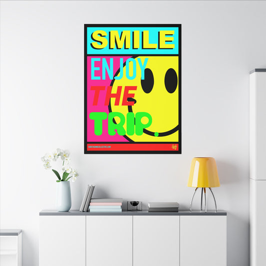 Colorful poster with smiley face and text 'SMILE ENJOY THE TRIP' on a white wall.