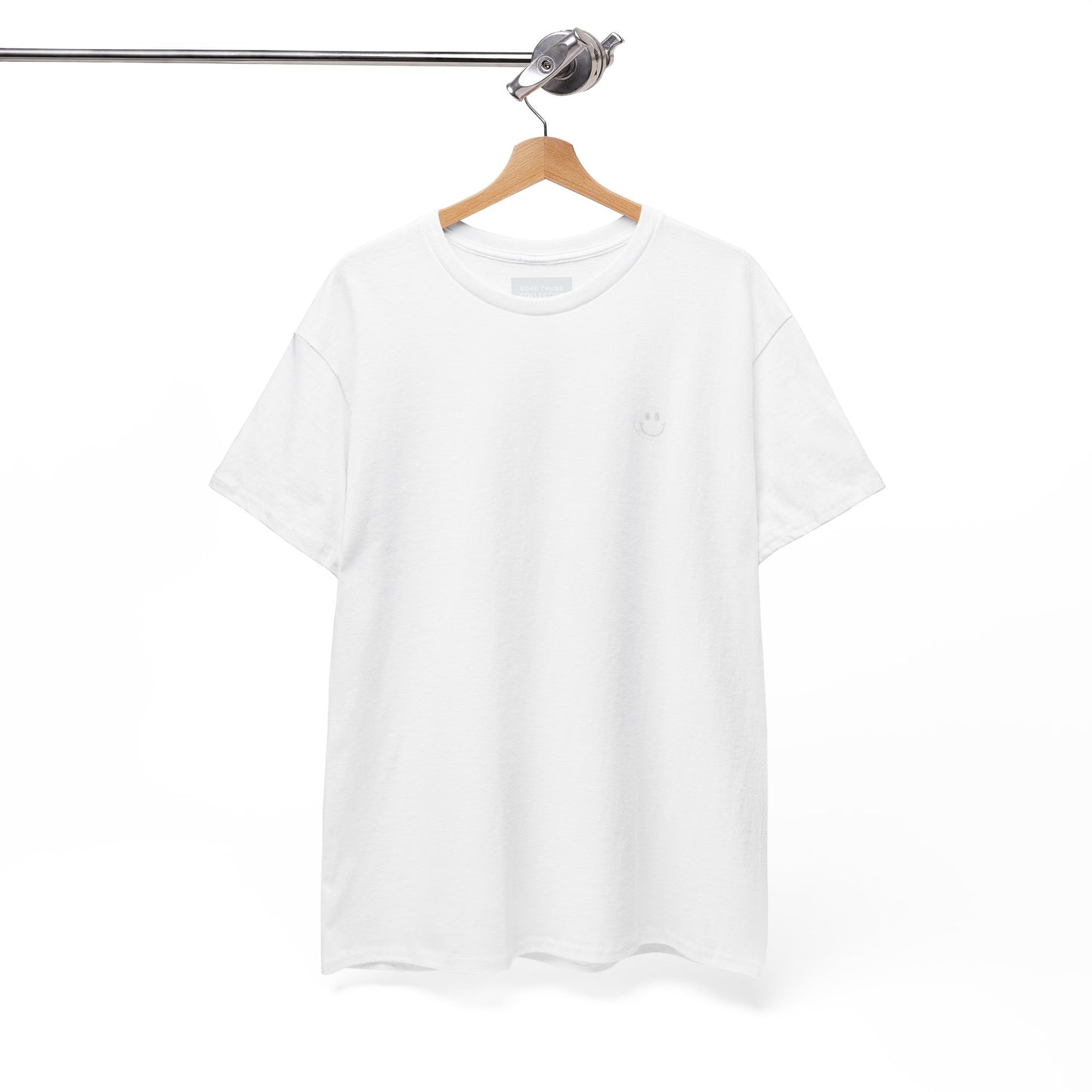 White t-shirt on a wooden hanger against a white background