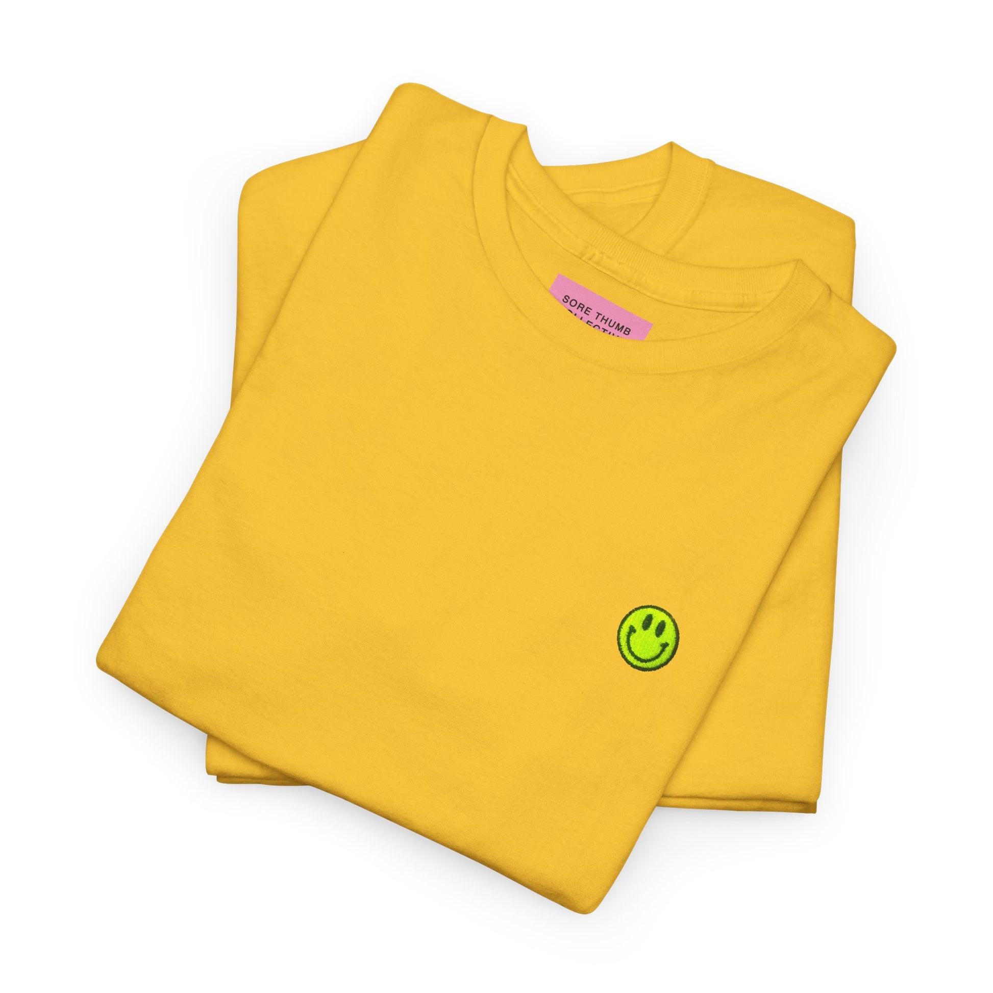 Yellow long-sleeve shirt with a green smiley face logo on a white background