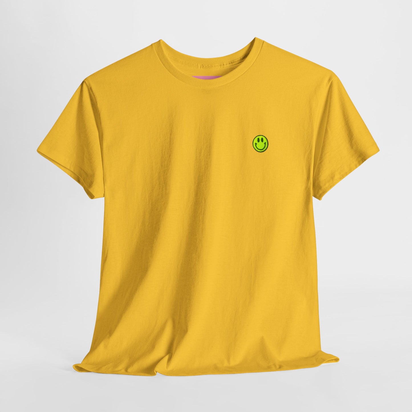 Yellow t-shirt with a green smiley face logo on a light gray background