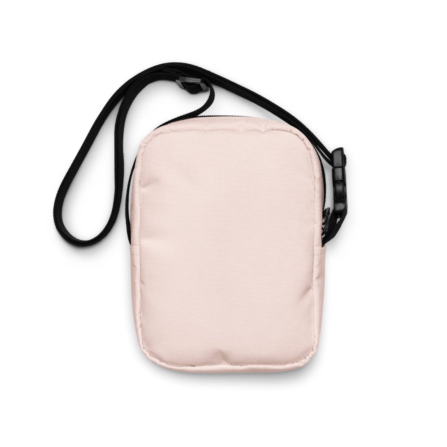 Pale pink crossbody bag, back view showing adjustable strap and made from strong, durable pale pink thick fabric