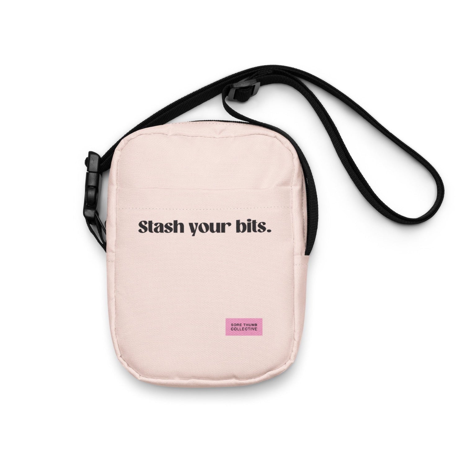 Pale pink crossbody bag, sized as a cross body bag for a festival. Utility style with front slogan print